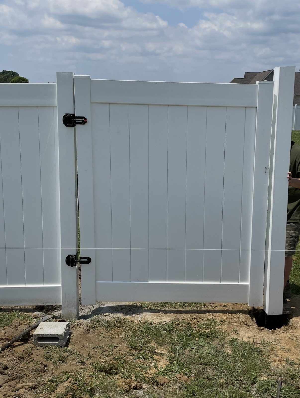 White vinyl privacy fence with a matching walk gate, freshly installed